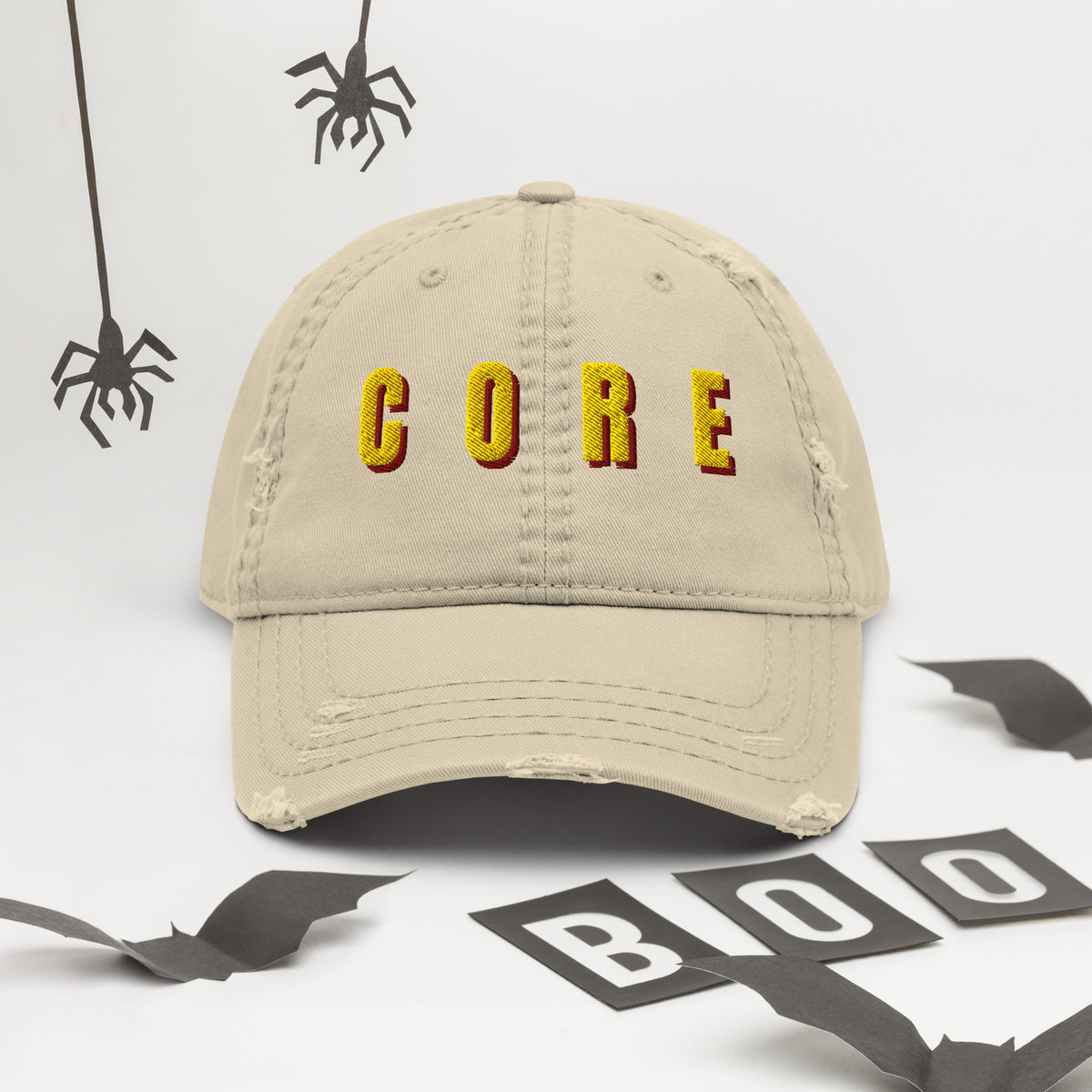 Khaki distressed dad hat with yellow and red CORE embroidered lettering