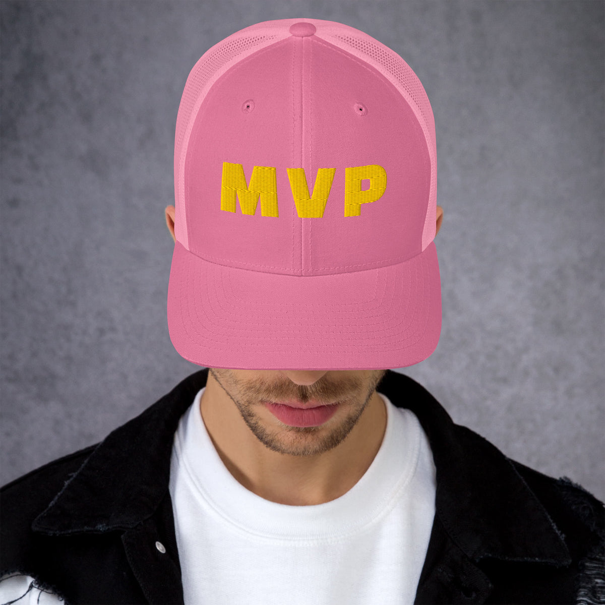 Man wearing a pink trucker hat with gold MVP embroidered lettering